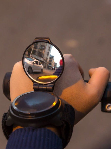 Wrist riding rear view mirror